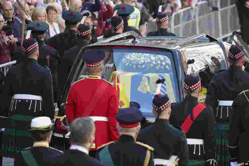 The procession with the coffin of Queen Elizabeth II, followed by King Charles III, Princess Anne, Prince Edward and Prince Andrew, heads up the Royal Mile to St. Giles' Cathedral in Edinburgh, Sept. 12, 2022.