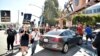Pickets carry signs outside Disney studios, July 20, 2023, in Burbank, Calif. The actors strike comes more than two months after screenwriters began striking in their bid to get better pay and working conditions.