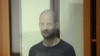 Wall Street Journal reporter Evan Gershkovich stands inside an enclosure for defendants as he attends a court hearing in Yekaterinburg, Russia, July 19, 2024. 