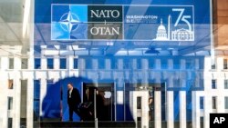 A NATO summit attendee walks through the Walter E. Washington Convention Center in Washington, on Tuesday, July 9, 2024. (AP Photo/Noah Berger)