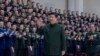In this photo released by Xinhua News Agency, Chinese President Xi Jinping waves as he meets with military officers stationed in north China's Tianjin Municipality ahead of the Chinese Lunar New Year, Feb. 2, 2024.