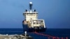 FILE - A ship rolls out fiber-optic cable, suspended from buoys, off La Guaira along the Venezuelan coast, Jan. 22, 2011. Undersea cables carry nearly all intercontinental internet traffic but are subject to many hazards, such as earthquakes and sabotage.