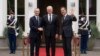 NATO Secretary General Jens Stoltenberg, left, and Dutch Prime Minister Mark Rutte, right, welcome Lithuania's President Gitanas Nauseda in The Hague, Netherlands, June 27, 2023. 