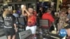 Michael Roche, (in black hat) and Denise Moline (in black), dance at an establishment in The Villages retirement community in Florida, Feb. 27, 2023.