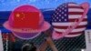 FILE - A vendor sets up foods and beverages at a booth displaying planets shaped of China and American flags during a Spring Carnival in Beijing on May 13, 2023.