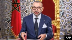 This handout picture provided by the Moroccan agency press (MAP) on July 30, 2023, shows Morocco's King Mohammed VI delivering a speech to the nation, marking the 24th anniversary of his accession to the throne, 