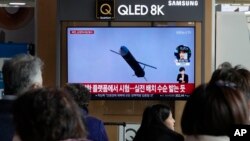 A TV screen shows a file image of North Korea's missile launch during a news program at the Seoul Railway Station in Seoul, South Korea, Feb. 14, 2024. 