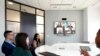 Workers in the office collaborate with virtual peers at American Express, where colleagues can work in the office, at home, or adopt a hybrid schedule, March 16, 2022, in New York. (American Express via AP Images)