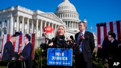 Rep. Marjorie Taylor Greene, joined by Rep. Thomas Massie, says she'll call a vote next week on ousting House Speaker Mike Johnson, during a news conference in Washington, May 1, 2024.