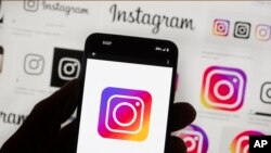 FILE - The Instagram logo is seen on a cellphone in Boston, Oct. 14, 2022.