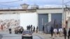 FILE - A general view of men in uniform outside the central prison in Libreville, Gabon, Sept. 11, 2023. Police in Gabon say a crime wave has hit the capital Libreville several days after the country’s transitional president pardoned and set free over 500 prisoners.