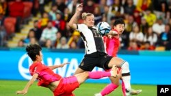 South Korea's Kim Hye-ri kicks the ball clear of Germany's Alexandra Popp in a World Cup match in Brisbane, Australia, on Aug. 3, 2023.