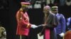 Archbishop of Libreville Jean-Patrick Iba-Ba, right, receives the report from Transitional President General Brice Oligui Nguema at the opening of the National Dialogue in Gabon at the Libreville Gymnasium, April 2, 2024.