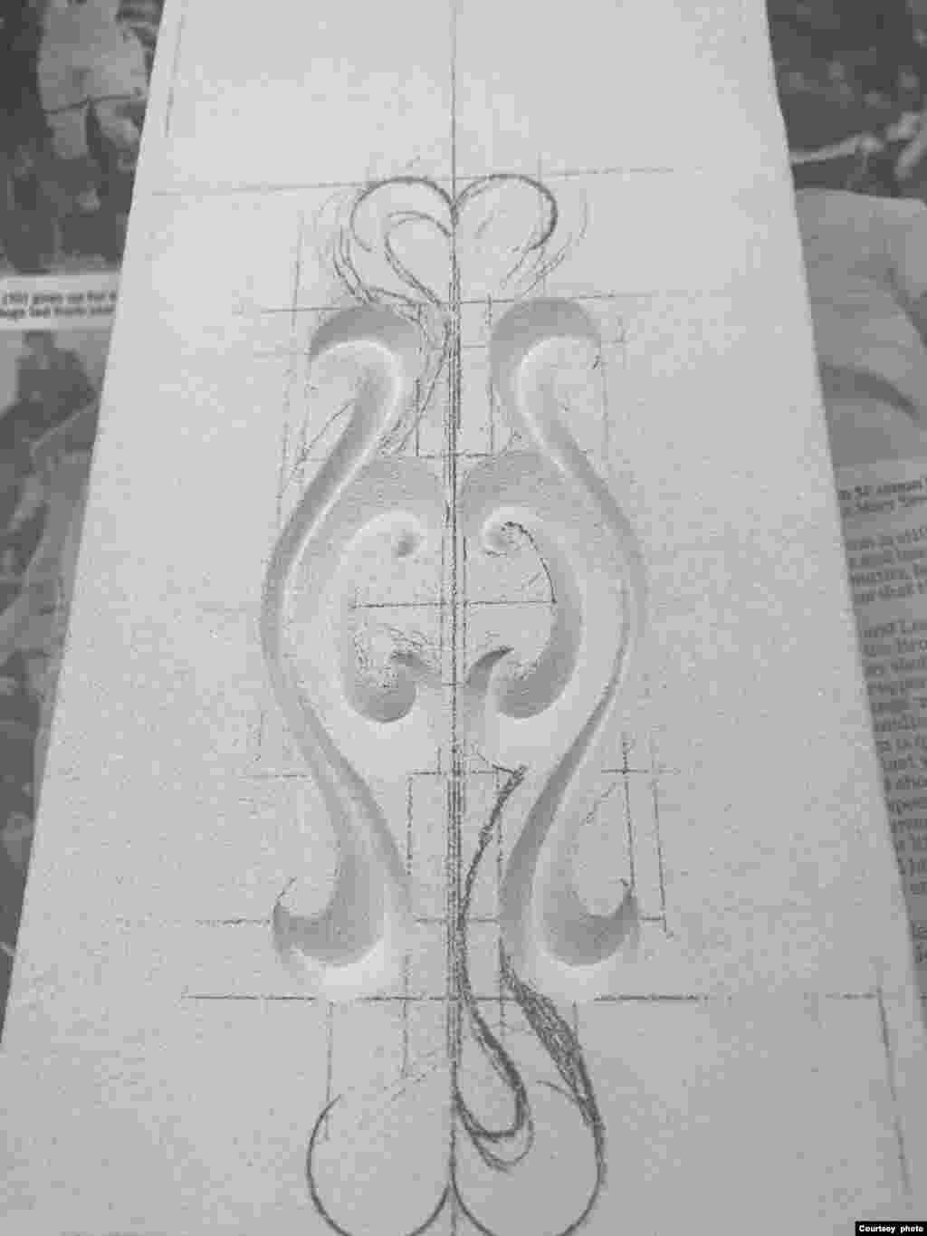 The artist carves the design into the stone, adding a channel through which molten silver will later be poured. 