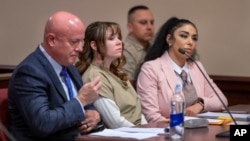 Hannah Gutierrez-Reed, center, prepares for a sentencing hearing in state district court in Santa Fe, New Mexico, April 15, 2024. (Eddie Moore/The Albuquerque Journal via AP, Pool)
