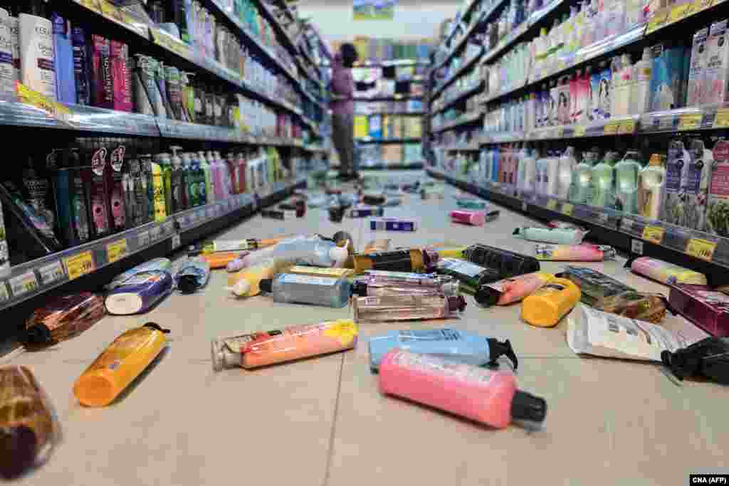 This photo taken by Taiwan's Central News Agency (CNA) on April 3, 2024 shows bottles strewn on the floor of a supermarket in Yilan, after a major earthquake hit Taiwan's east.