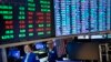 Traders work on the floor at the New York Stock Exchange in New York, Jan. 23, 2024.