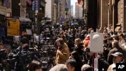 Members of the media gather outside Trump Tower in New York City, April 3, 2023.