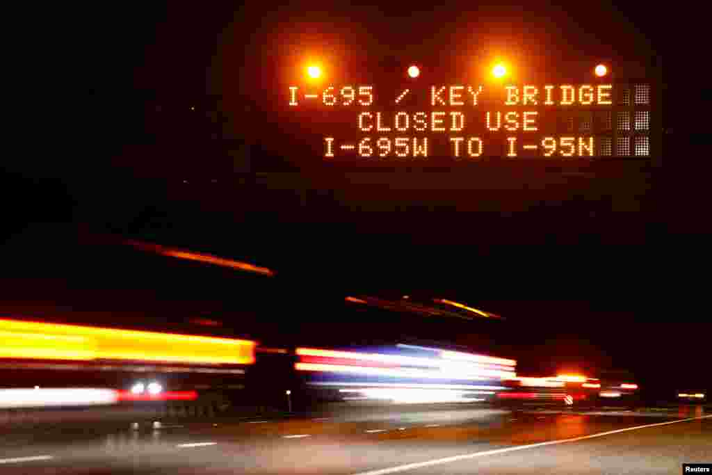 Highway signs direct drivers to a detour for Francis Scott Key Bridge following the bridge's collapse, in Baltimore, March 26, 2024.