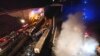 Smoke rises from trains as firefighters and rescuers operate after a collision near Larissa city, Greece, early March 1, 2023. 