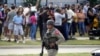 A law enforcement officer walks as people are evacuated from a shopping center where a shooting occurred May 6, 2023, in Allen, Texas. 