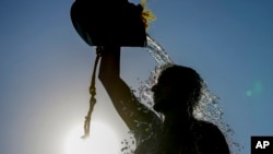 FILE - A man rinses with fresh water on a sweltering hot day, at the Ramlet al-Baida public beach in Beirut, Lebanon, July 16, 2024. 