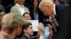 U.S. President Joe Biden talks to Harry Abramson during a visit to the Biden campaign office in Milwaukee, Wisconsin, March 13, 2024. 