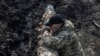 Seorang anggota pasukan Ukraina berdiri di dekat sebuah tank di dekat garis depan pertempuran di Kota Bakhmut, Ukraina, pada 10 April 2023. (Foto: Reuters/Oleksandr Klymenko)
