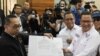 Ketua Tim Kuasa Hukum Paslon Presiden dan Wakil Presiden 01, Ari Yusuf Amir (kanan) memberikan berkas PHPU Pemilu Presiden 2024 ke perwakilan MK di Jakarta, Kamis (21/3). (VOA/IndraYoga)