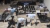 Senjata api dan barang-barang yang disita Densus 88 usai penangkapan seorang pria yang diduga simpatisan ISIS di Bekasi, 14 Agustus 2023. (Foto: Antara/Fakhri Hermansyah via REUTERS)