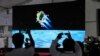 Journalists film the live telecast of spacecraft Chandrayaan-3 landing on the moon at ISRO's Telemetry, Tracking and Command Network facility in Bengaluru, India, Aug. 23, 2023. 