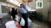 People receive charity ration sacks from the Saylani Welfare Trust's office, a non-government organization focusing primarily on feeding the poor and homeless, in Karachi, Pakistan, April 3, 2023.