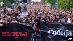 People march during a rally against violence in Belgrade, Serbia, May 12, 2023.