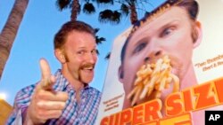FILE - Morgan Spurlock poses at the Los Angeles premiere of his film "Super Size Me," in the Hollywood section of Los Angeles, April 22, 2004.