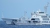 Sebuah kapal Penjaga Pantai China dengan nomor haluan 5201 menghadang kapal Penjaga Pantai Filipina BRP Malapascua saat bermanuver memasuki muara Second Thomas Shoal yang dikenal sebagai Ayungin Shoal di Laut Cina Selatan pada Minggu, 23 April 2023. (AP/Aaron Favila)