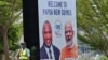 A security worker stands next to a banner featuring Papua New Guinea's Prime Minister (L) and India's Prime Minister Narendra Modi in Port Moresby, May 18, 2023. 