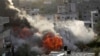 Smoke and fire rise from an explosion caused by an Israeli airstrike targeting a building in Gaza, May 13, 2023. 