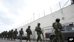 Sejumlah anggota kepolisian dan tentara bersiap memasuki penjara El Inca di Quito, Ekuador, untuk meredakan kerusuhan yang terjadi di dalamnya pada 8 Januari 2024. (Foto: AP/Dolores Ochoa)