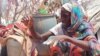 Fatma Idriss of Sudan cooks in a refugee camp in Adre, Chad, on Sept. 13, 2023.