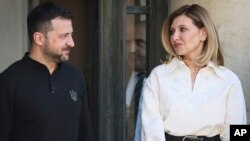 FILE - Ukrainian President Volodymyr Zelenskyy and his wife Olena Zelenska look at each other during a visit to the Elysee Palace in Paris, France, June 7, 2024.