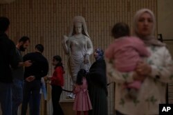 People visit the Iraqi National Museum in Baghdad, Iraq, Friday, Feb. 24, 2023, which reopened to the public after months or maintenance work.
