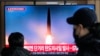 FILE - A TV screen shows a North Korean missile launch during a news program at the Seoul Railway Station in South Korea, Dec. 18, 2023. Some analysts say the U.S. should impose new sanctions on China to pressure Beijing into cracking down on North Korea's weapons programs.