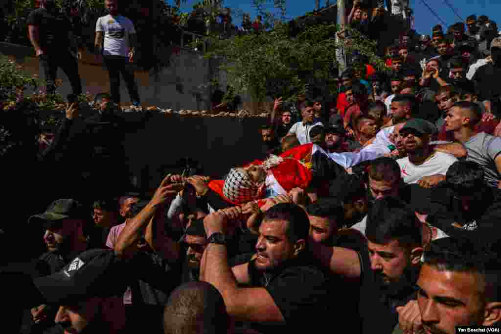 The body of Ahmad Ghaleb, 16, is taken to be buried in the Qalandia Refugee Camp's cemetery, Oct. 25, 2023. Ghaleb was killed during a Israeli incursion into the camp to arrest people suspected of being part of the militant group Hamas.