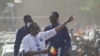FILE - Success Masra, center, gestures as he arrives for a meeting of the Chadian political party Succes Masra (C) gestures as he arrives for a meeting of the Chadian political party The Transformers, in N'Djamena, March 10, 2024.