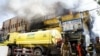Somali police stand guard after an explosion at a shopping mall area that caused fire at the Bakara market in Mogadishu, March 10, 2024.