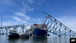 The fallen Francis Scott Key Bridge in Baltimore is pictured March 31, 2024, where divers assisted crews with the complicated and meticulous operation of removing steel and concrete. 