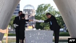 Hiroshima Mayor Kazumi Matsui and representatives of bereaved families enshrine a list of the atomic bomb victims at the cenotaph during a ceremony at the Peace Memorial Park in Hiroshima, Aug. 6, 2023.