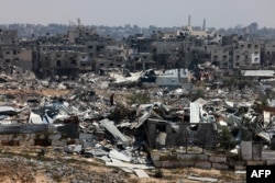 A man stands in the midst of devastation caused by months of Israeli bombardment in Khan Yunis on Apr. 7, 2024, after Israel pulled its ground forces out of the southern Gaza Strip.