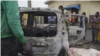 FILE - In this image taken from video, people observe the aftermath of an attack by armed militants in Cameroon's South West region on Sept. 9, 2023. The militants stopped cars, shot at passengers and set vehicles ablaze in the village of Muea, killing at least two people.