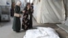 Mourners react next to the bodies of Palestinians killed in an Israeli strike, at Abu Yousef al-Najjar hospital in Rafah, May 5, 2024. 